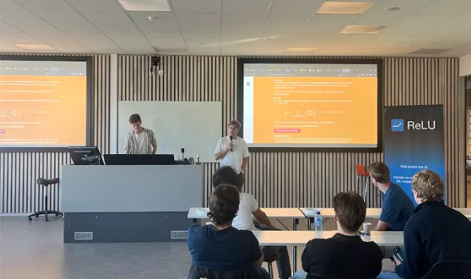 Two members presenting in front of an Estimathon problem set.